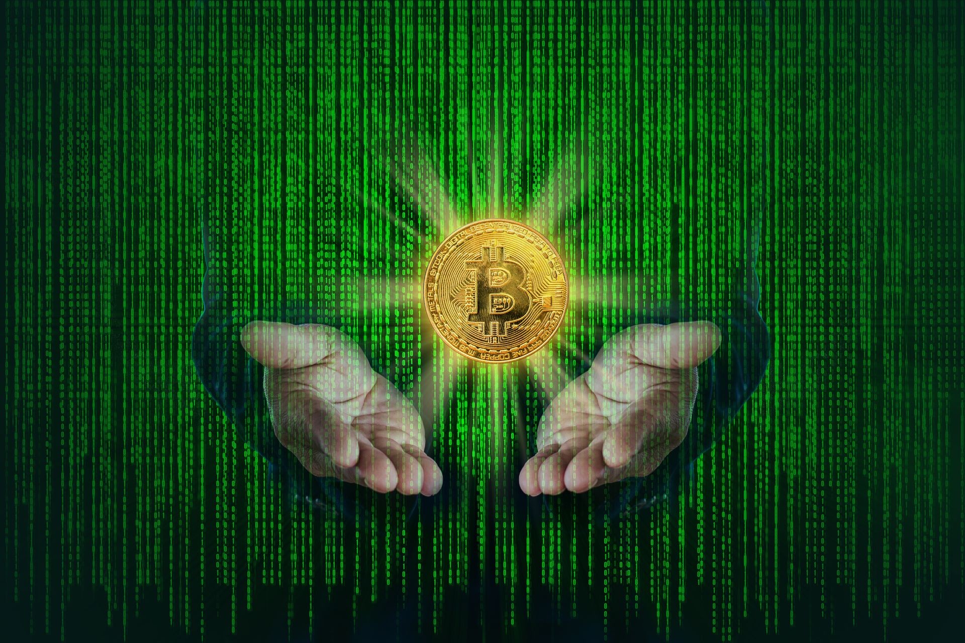 Bitcoin golden metallic coin on hands of business with binary code of matrix effect background.